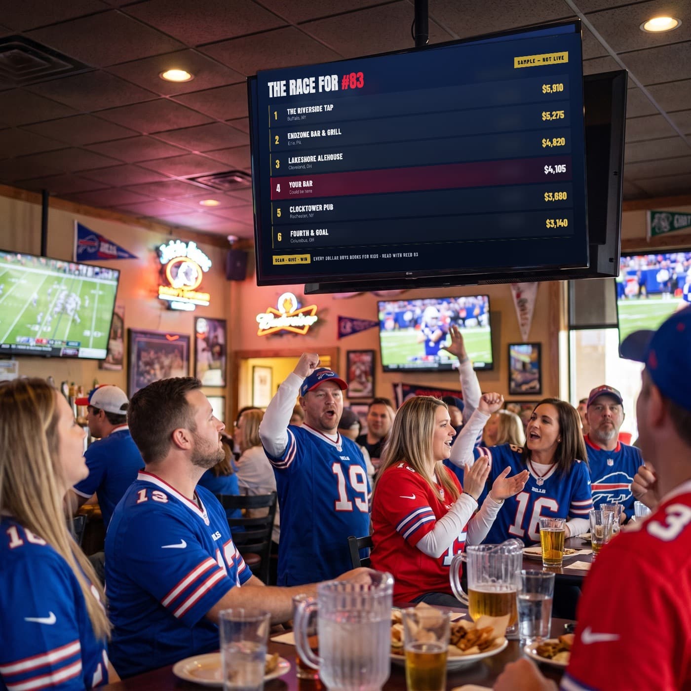 The Challenge standings on a screen above a crowd of Bills fans in a bar