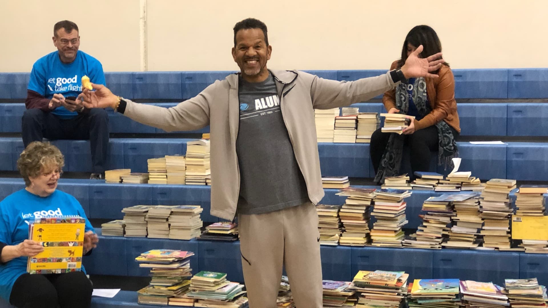 Andre Reed with stacks of donated books